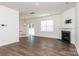 Bright living room featuring hardwood floors, fireplace, and sliding glass door at 3933 Meadow Green Dr, Charlotte, NC 28269