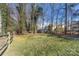 Landscaped backyard with a storage shed and privacy fence at 4436 Tilley Morris Rd, Matthews, NC 28105