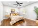 Well-lit bedroom with a queen-size bed and wood flooring at 4436 Tilley Morris Rd, Matthews, NC 28105