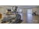 Home gym and living space in finished basement with modern fitness equipment and comfortable seating at 45528 Misty Bluff Dr, Charlotte, NC 28278