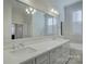 Bathroom with double vanity, large mirror, and soaking tub at 45528 Misty Bluff Dr, Charlotte, NC 28278
