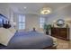 Spacious main bedroom with a king-size bed and hardwood floors at 45528 Misty Bluff Dr, Charlotte, NC 28278