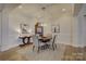 Elegant dining room features a round table, chandelier, and hardwood floors at 45528 Misty Bluff Dr, Charlotte, NC 28278