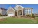 Attractive two-story home with stone exterior and landscaping at 45528 Misty Bluff Dr, Charlotte, NC 28278