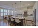 Modern kitchen boasts stainless steel appliances and island with seating at 45528 Misty Bluff Dr, Charlotte, NC 28278