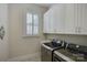 Laundry room with ample cabinetry and modern LG washer and dryer at 45528 Misty Bluff Dr, Charlotte, NC 28278