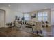 Spacious living room with hardwood floors, comfy seating, and large windows at 45528 Misty Bluff Dr, Charlotte, NC 28278
