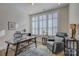 Spacious home office with large windows and a comfortable sitting area at 45528 Misty Bluff Dr, Charlotte, NC 28278