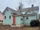 Rear view of a charming teal house with a red door and mature trees at 507 Park Ave, Salisbury, NC 28144