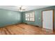 Light-green walls and wood floors in this bedroom at 539 Bethlehem Rd, Statesville, NC 28677