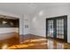 Living room with hardwood floors and French doors leading to balcony at 5601 Fairview Rd # 22, Charlotte, NC 28209