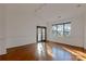 Living room with hardwood floors and French doors leading to balcony at 5601 Fairview Rd # 22, Charlotte, NC 28209