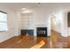 Living room with hardwood floors, fireplace, and built-in shelving at 5601 Fairview Rd # 22, Charlotte, NC 28209