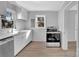 Modern kitchen with white cabinets, stainless steel appliances, and quartz countertops at 611 Clarinda St, Rock Hill, SC 29730