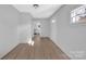 Living room with light gray walls, wood-look floors, and access to the kitchen at 611 Clarinda St, Rock Hill, SC 29730