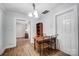 Simple dining area with table and chairs, hardwood floors, and access to other rooms at 621 Flint St, Rock Hill, SC 29730