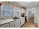 White kitchen with stainless steel appliances and double sink at 621 Flint St, Rock Hill, SC 29730