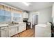 White kitchen with stainless steel appliances and view to laundry area at 621 Flint St, Rock Hill, SC 29730