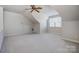 Spacious bonus room with ceiling fan and window at 8512 Willow Branch Dr, Waxhaw, NC 28173