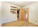 Simple bedroom with wood floors and built-in shelving at 10109 Windrift Rd, Charlotte, NC 28215