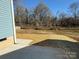 Backyard with straw covering and tree line at 1026 N Oakwood St, Gastonia, NC 28052