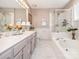 Elegant bathroom with double vanity and a soaking tub at 10321 Shelter Rock Ct, Charlotte, NC 28214