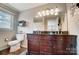 Well-lit bathroom with double vanity, large mirror, and toilet, blending style and functionality for a refreshing experience at 109 Chanticleer Ct, Charlotte, NC 28214