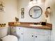 Bathroom with a single vanity and a round mirror at 109 Chanticleer Ct, Charlotte, NC 28214