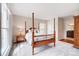 Bright bedroom featuring a classic four-poster bed, soft carpet, and a view to an adjacent room providing a serene retreat at 109 Chanticleer Ct, Charlotte, NC 28214