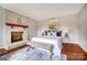 Charming bedroom with a cozy fireplace, accent rug, a comfortable bed, and complementary furniture adding warmth and style at 109 Chanticleer Ct, Charlotte, NC 28214
