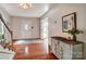 Inviting foyer with hardwood floors, staircase, and decorative entryway furniture at 109 Chanticleer Ct, Charlotte, NC 28214