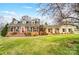 Charming brick home with a well-manicured lawn and inviting front porch and dormer windows at 109 Chanticleer Ct, Charlotte, NC 28214