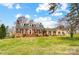 Lovely brick home with dormer windows, a well-kept lawn, and a cozy porch for relaxing outdoors at 109 Chanticleer Ct, Charlotte, NC 28214