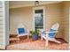 Cozy front porch with white Adirondack chairs and a charming brick floor at 109 Chanticleer Ct, Charlotte, NC 28214