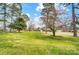 Well-maintained front yard with mature trees, offering a peaceful and inviting curb appeal at 109 Chanticleer Ct, Charlotte, NC 28214