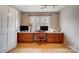 Bright home office featuring built-in desk, storage cabinets and large window with natural light at 109 Chanticleer Ct, Charlotte, NC 28214