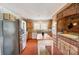 Rustic kitchen featuring brick accents, wooden cabinets, stainless steel appliances, and center island at 109 Chanticleer Ct, Charlotte, NC 28214