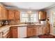 Charming kitchen featuring tile backsplash and warm-toned wooden cabinets at 109 Chanticleer Ct, Charlotte, NC 28214