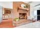 Classic brick fireplace with wooden mantel in a naturally-lit and welcoming living room at 109 Chanticleer Ct, Charlotte, NC 28214