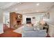 Bright living room with brick fireplace, exposed beams, and open floor plan at 109 Chanticleer Ct, Charlotte, NC 28214