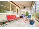 Inviting porch with colorful seating and a ceiling fan, designed for comfortable outdoor living at 109 Chanticleer Ct, Charlotte, NC 28214