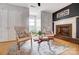 Inviting sitting area with cozy chairs, decorative rug, and fireplace, perfect for relaxation and conversation, enhancing the home's comfort at 109 Chanticleer Ct, Charlotte, NC 28214