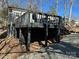 Exterior view showing home's deck and landscaping at 112 N Cardinal Badin Shores Dr, New London, NC 28127