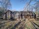 Back of house, dark wood siding, several windows, and a partially visible deck at 12 Woodvine Ln, Clover, SC 29710