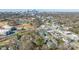Aerial view showing townhouses and surrounding neighborhood with city skyline at 1304 Queen Lyon Ct, Charlotte, NC 28205