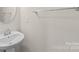 Small bathroom with pedestal sink and single towel bar at 1304 Queen Lyon Ct, Charlotte, NC 28205