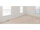 Bright bedroom with two windows and neutral wall colors at 1304 Queen Lyon Ct, Charlotte, NC 28205