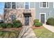 Gray townhome with brick base and a dark door at 1304 Queen Lyon Ct, Charlotte, NC 28205