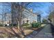 Townhome community featuring a gray building with landscaping at 1304 Queen Lyon Ct, Charlotte, NC 28205