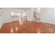 Spacious living room featuring hardwood floors and kitchen view at 1304 Queen Lyon Ct, Charlotte, NC 28205